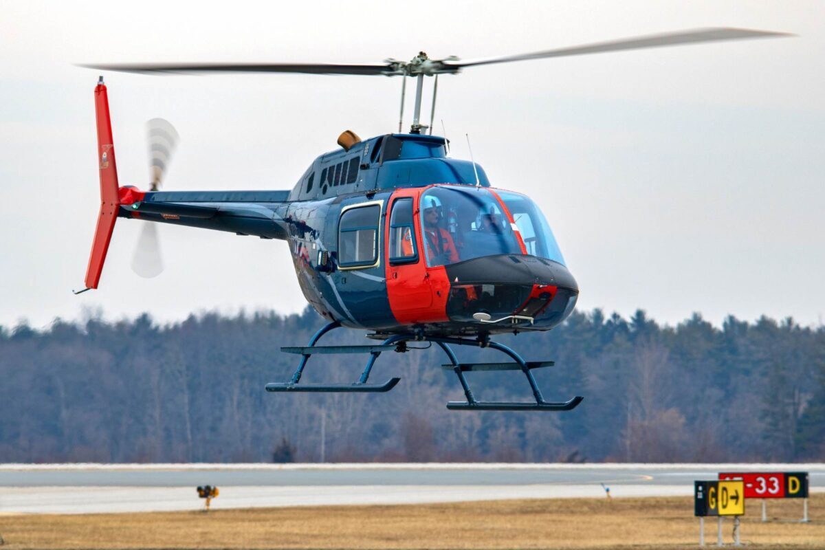 bell 206 rotary wing hovering above runway