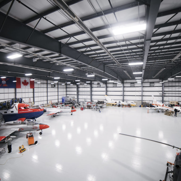 Airplane hangar with multiple planes and helicopters.