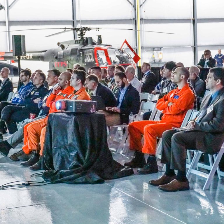 Attendees at Annual Flight Test Seminar and Graduation at International Test Pilots School hangar.