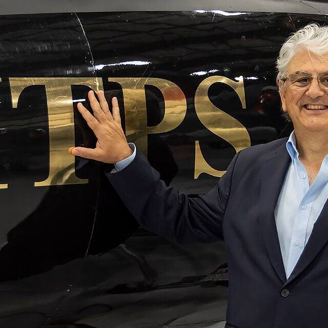 Giorgio Clementi with black Hunter aircraft touching gold ITPS letters on black hawker hunter
