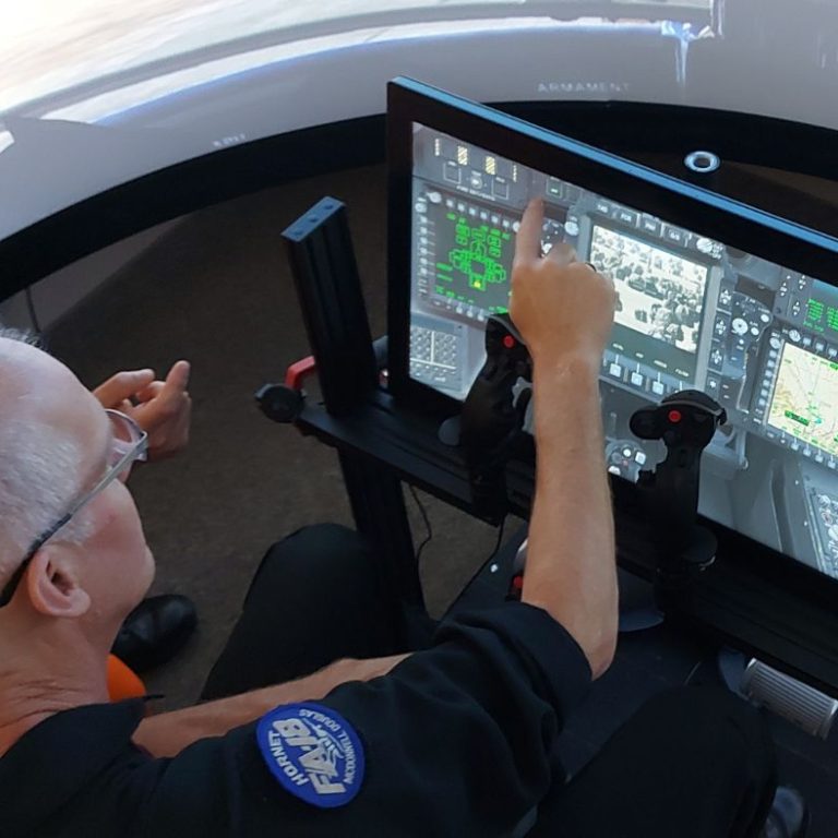 Steve Bigg demonstrating Attack Helicopter simulator in Advanced Aircraft Simulation Centre