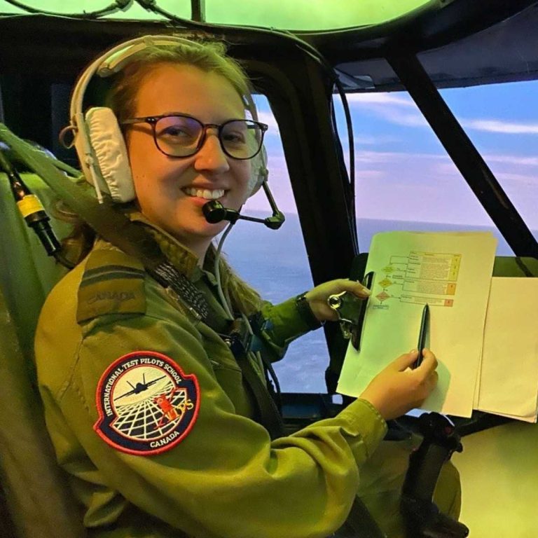 student in aircraft simulator holding flight test checklist