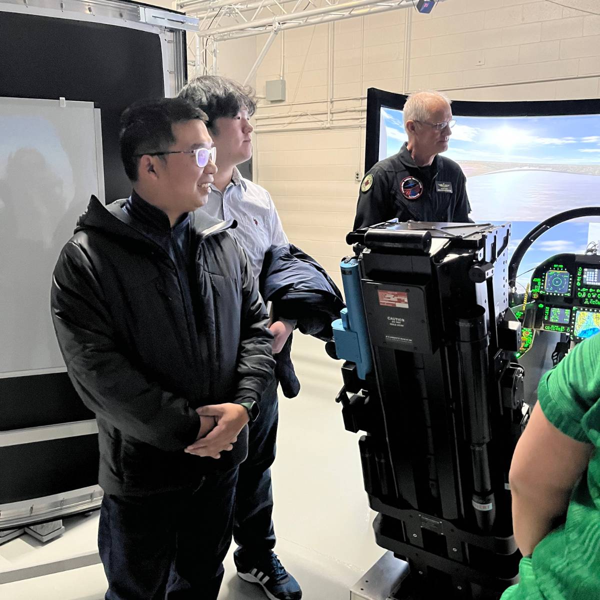 Students from University of Waterloo smiling during visit to ITPS and Advanced Aircraft Simulation Centre AASC