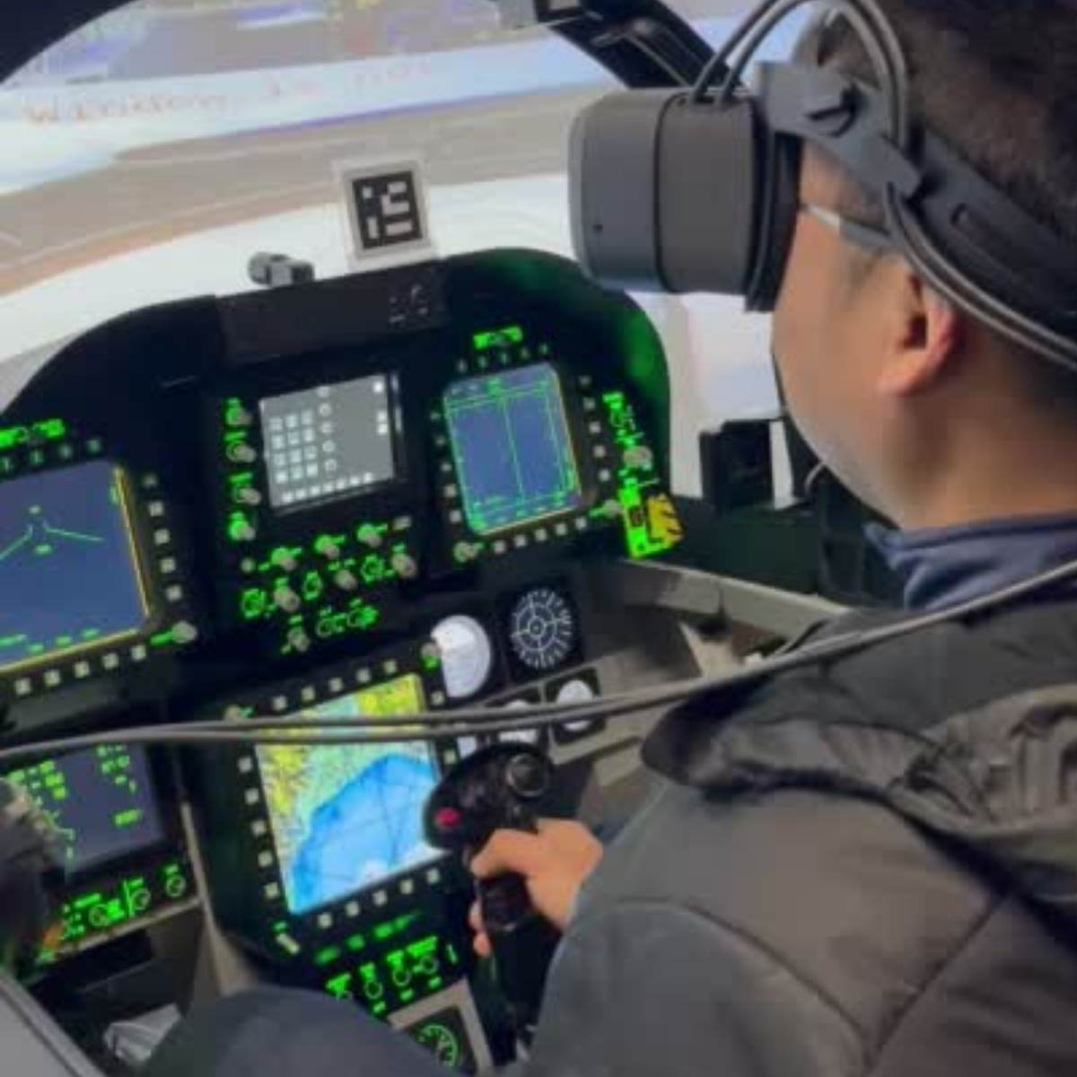Student at University of Waterloo in cockpit wearing Mixed reality headset goggles