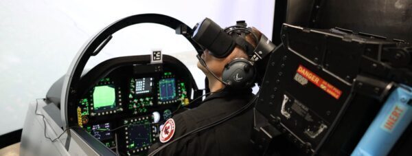 Brendan Darcee Pierce, VP of Tactical Training sitting in Mixed-Reality Simulator