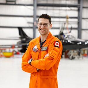 Vaugh Guigui in orange flight suit at ITPS