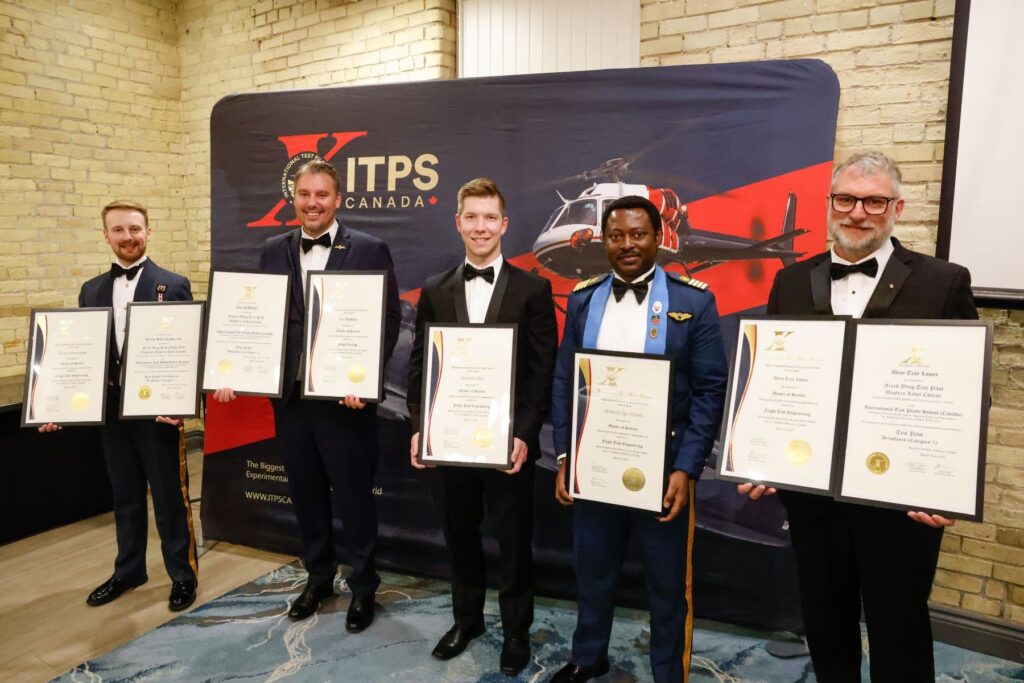 1749656862343 graduates stand with certifications
