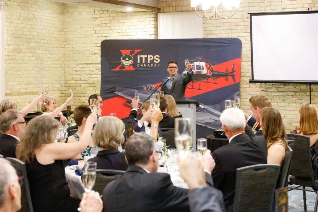 1749656862361 Thiago Macedo, Head of Training, raising a glass to seated audience