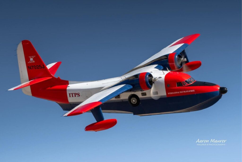1 HU-16 flying in front of blue sky