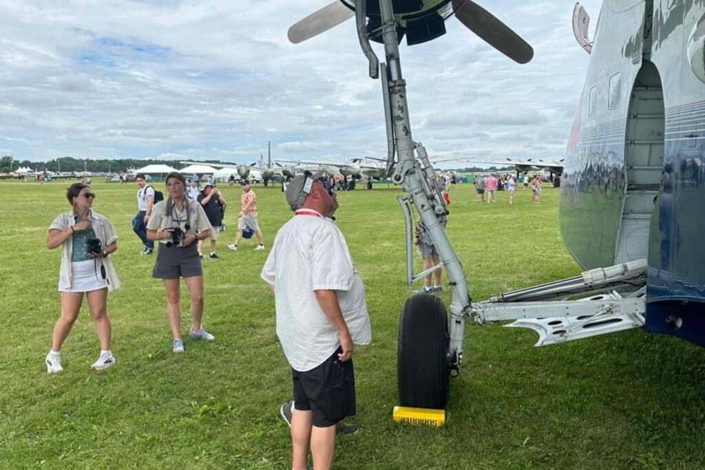 12 spectators looking at HU-16 landing gear