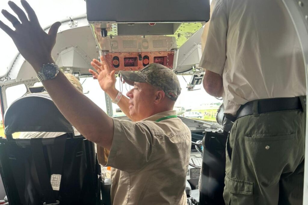 13 Airshow attendee raising arms in HU-16 cockpit