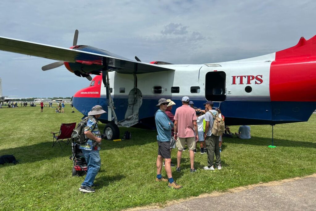 15 spectators gathered around ITPS branded HU-16 Albatross