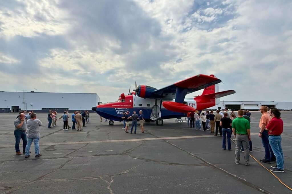 2 Spectators look at HU-16 on ramp