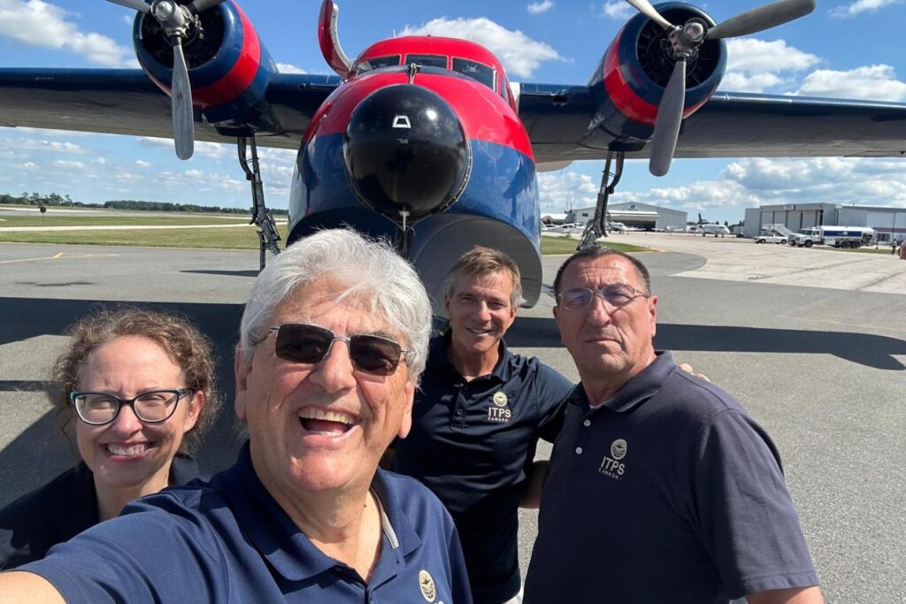 4 ITPS team arrive in Canada after USA tour, in front of HU-16 on ramp