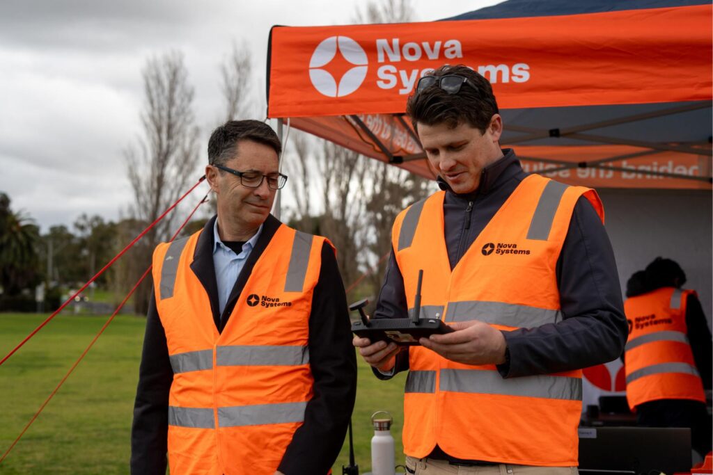 4 Nova member holding UAS controller while Michael Mulquiney stands watching