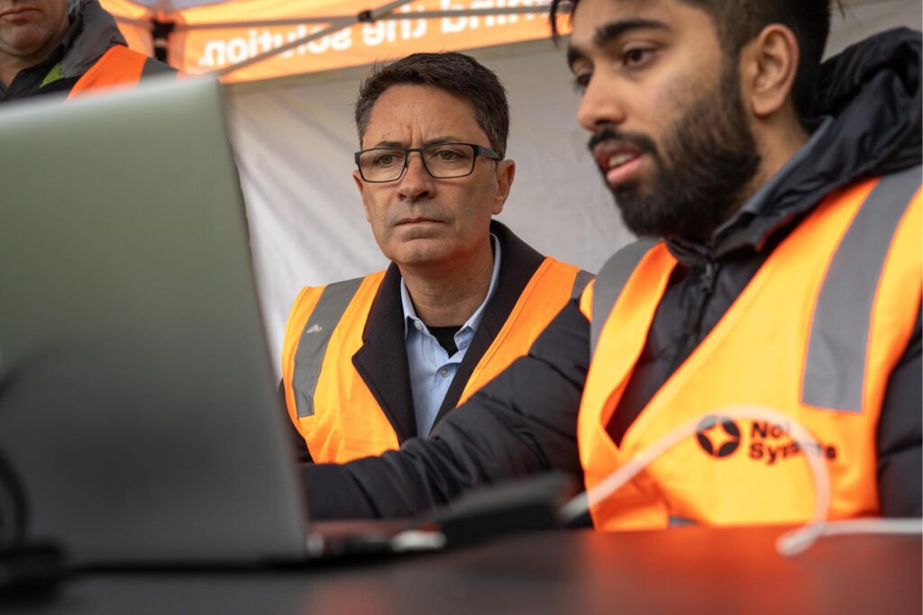 6 Michael Mulquiney watches with intent as Nova member shows him a laptop screen