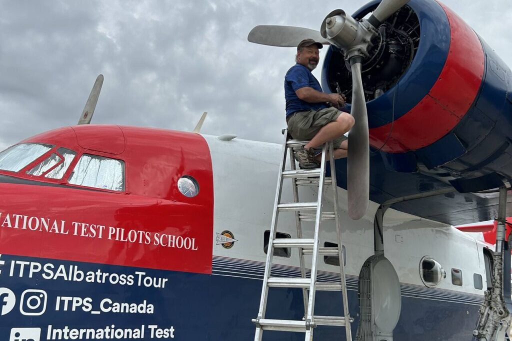 6 Todd Polcher on ladder working on HU-16 Albatross Propeller