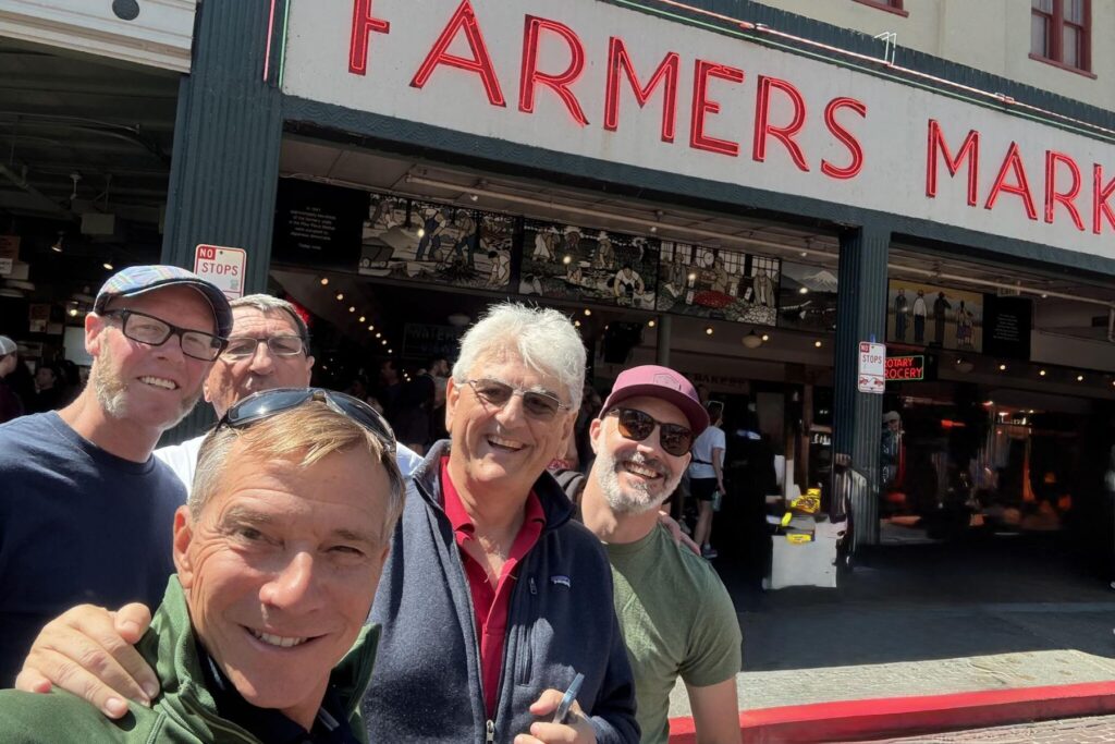7 ITPS group stand together in front of Farmers Market in Seattle