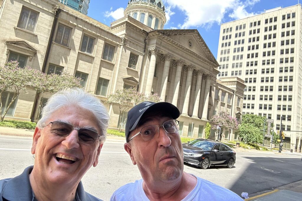 8 Giorgio Clementi standing beside Stan Constantin in front of buildings