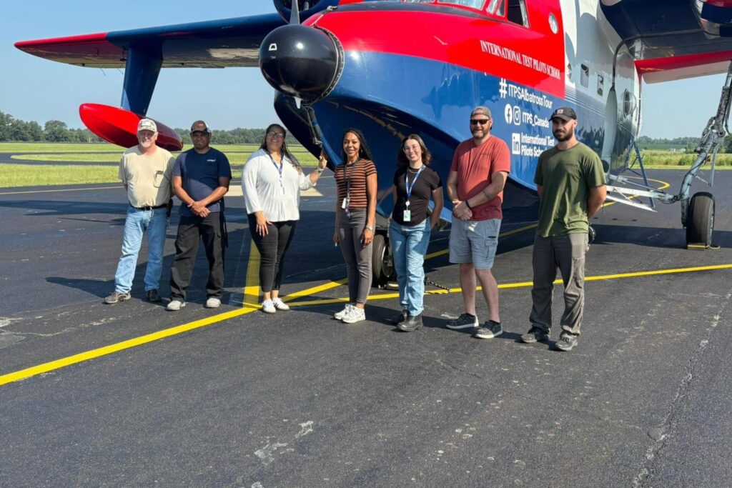8 Spectators in front of HU-16 parked on ramp