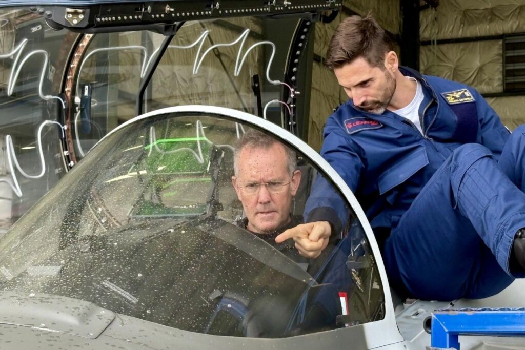 1 Leonardo team member pointing at cockpit while Dave Lohse spectates