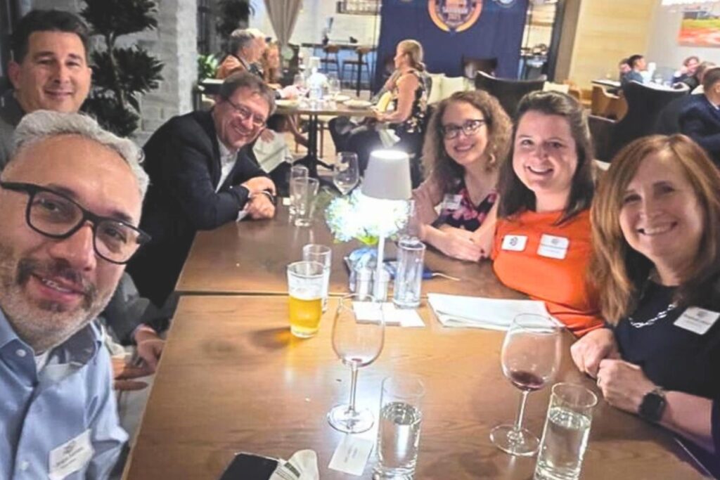 3 SFTE symposium attendees gathered around table