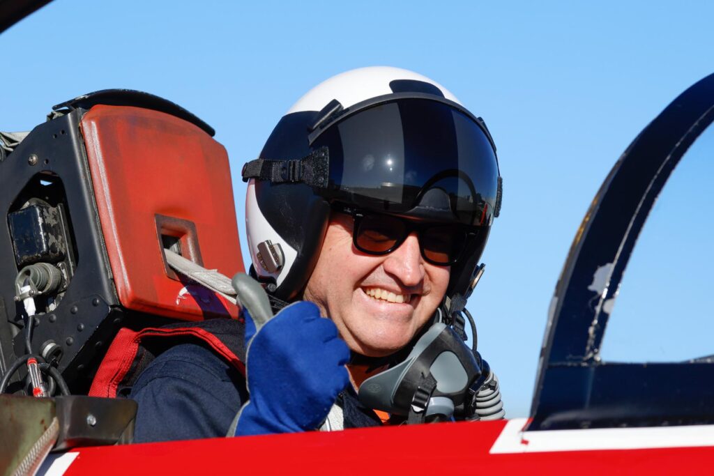 yes ITPS student giving thumbs up in jet cockpit
