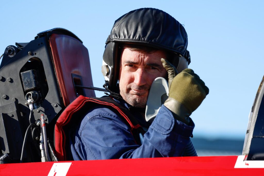yes (3) Test pilot student seated in airplane cockpit giving thumbs up