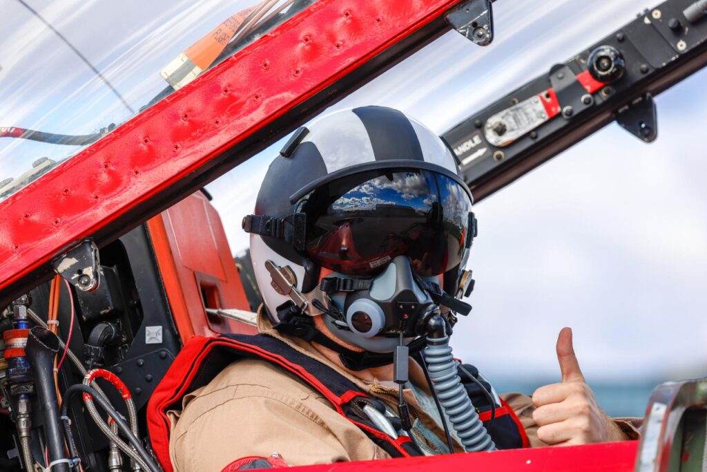 yes (5) ITPS test pilot in t-33 bird cockpit giving thumbs up