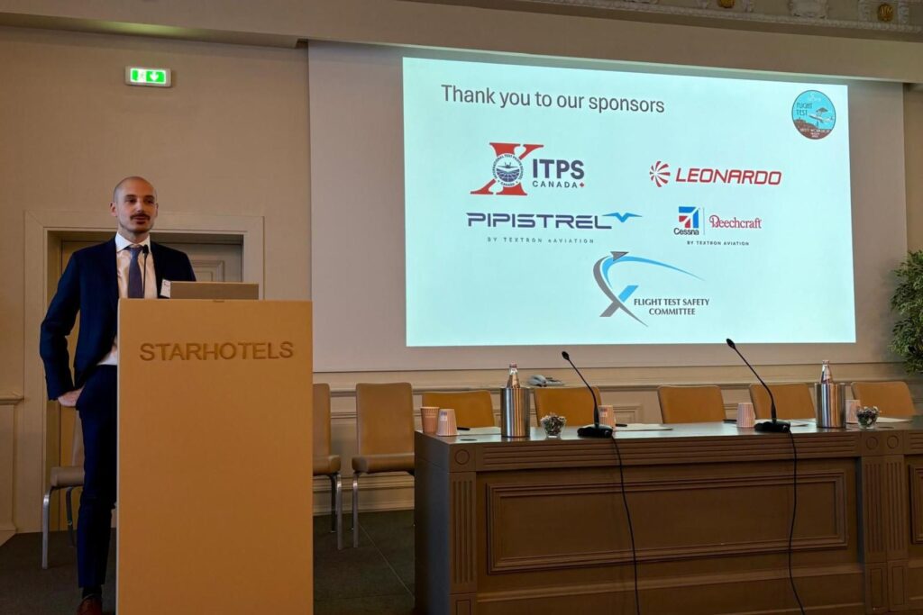 2 speaker at podium of Flight Test Safety Committee workshop, ITPS as a listed sponsor