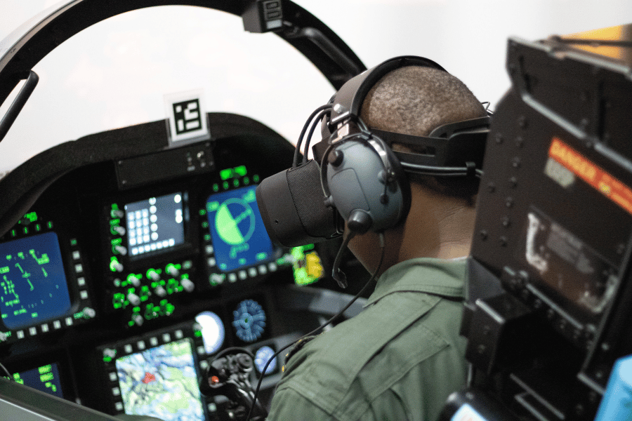 student in fighter jet cockpit with mixed reality