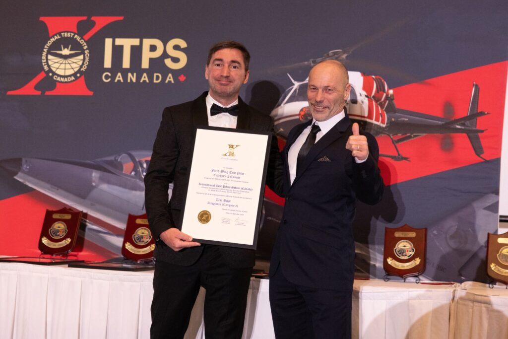 Grac Williams with student holding plaque