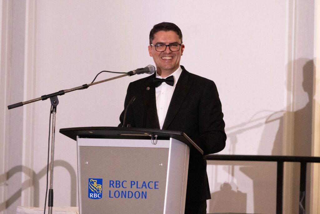 Thiago Macedo, Head of Training, ITPS at podium attending graduation guests