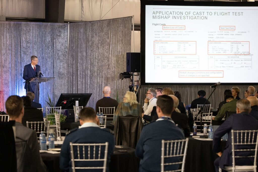 ITPS presenter at podium as spectators look at screen