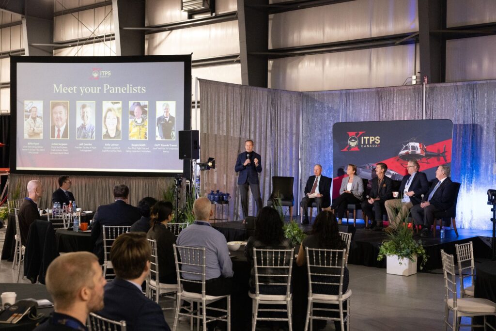 Billie Flynn with ITPS flight test seminar panelists in front of crowd