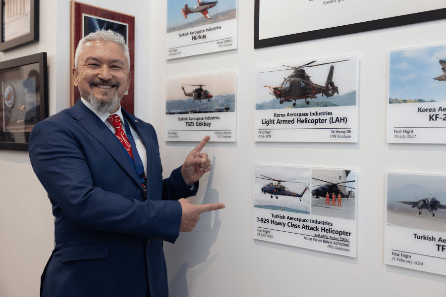 3 Arif Ates pointing to his plaques of his first flights with Turkish Aerospace