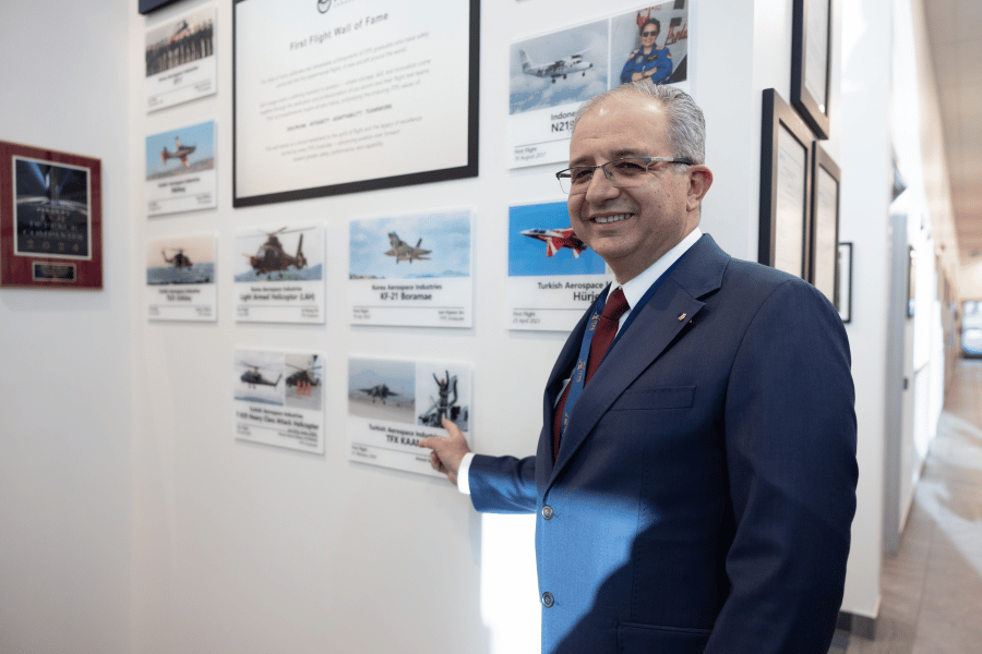 4 Barbaros Demirbas pointing to his KAAN first flight plaque of ITPS wall of fame