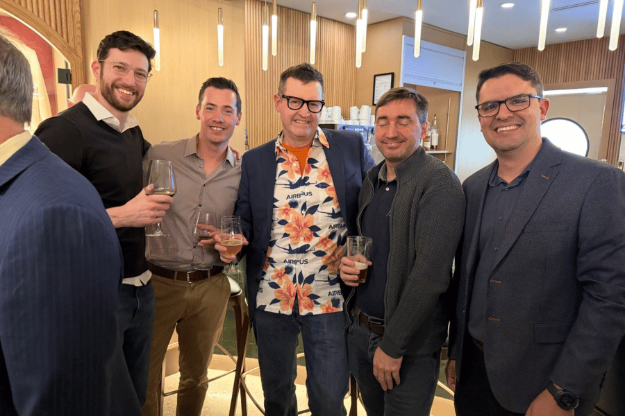 7 ITPS instructors, alumni and guests smiling at Hard Rock Hotel