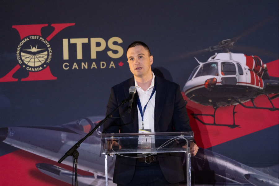 7 presenter at ITPS flight test seminar standing at podium