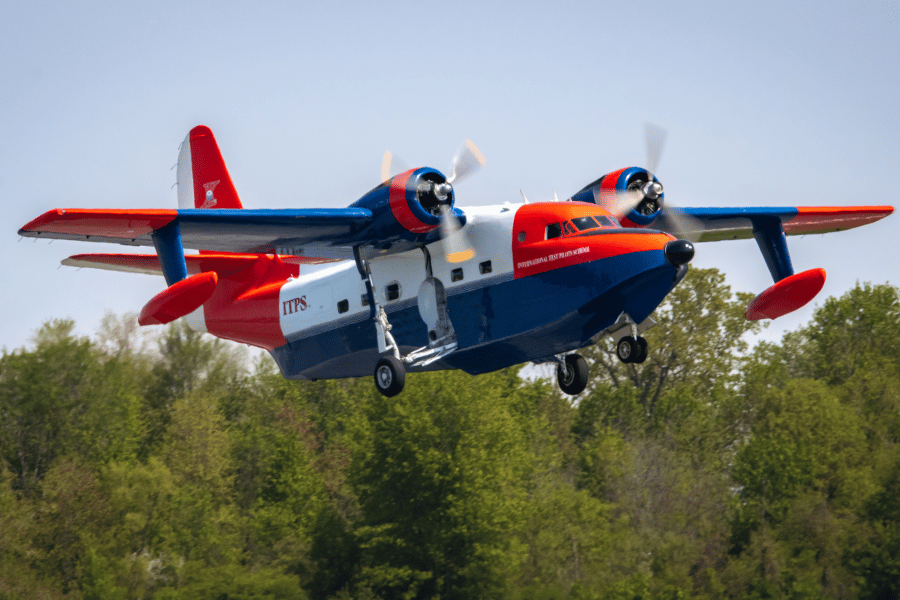 HU-16C Albatross flying above trees at London Intl. Airport