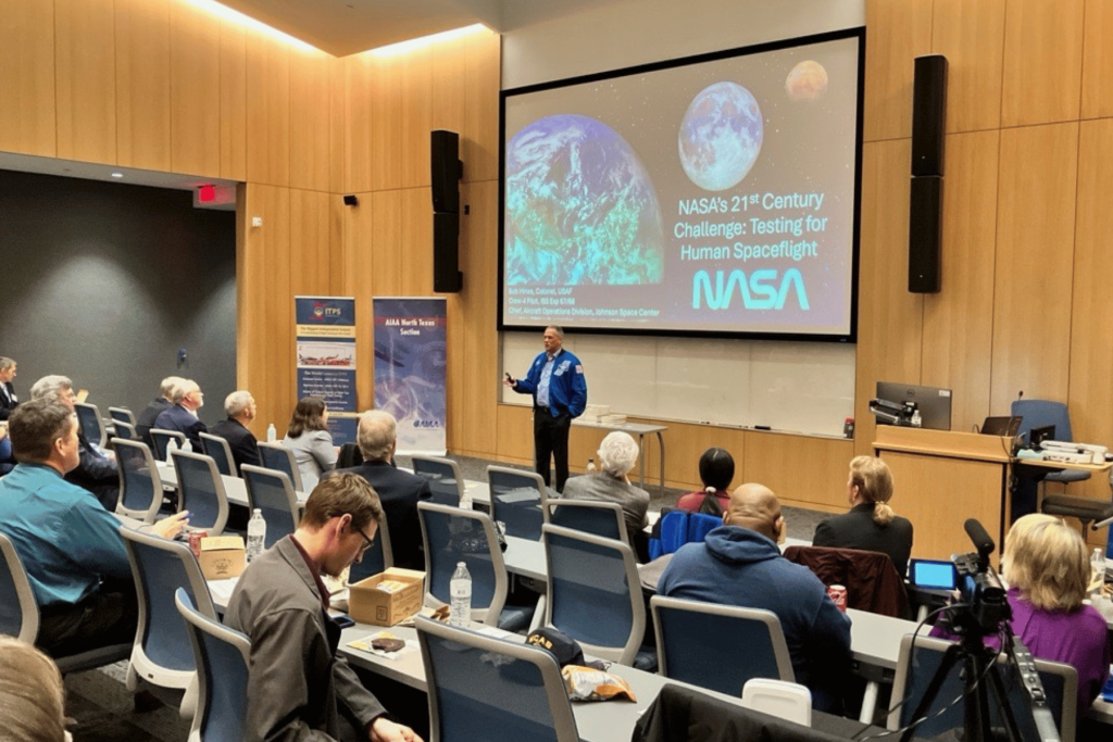 Lecture hall filled with Flight test professionals onlooking a NASA presentation