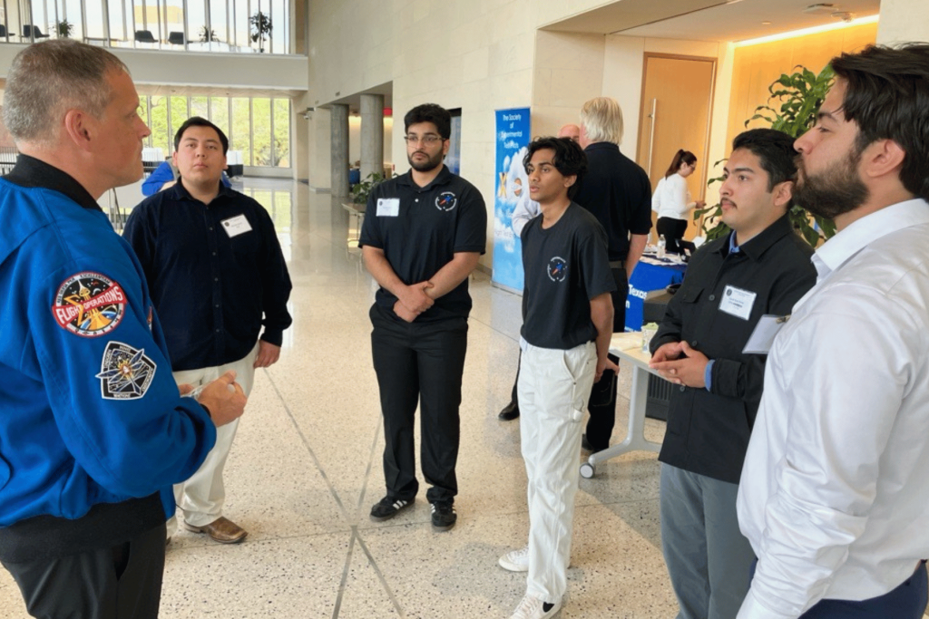 NASA presenter standing with flight test professionals
