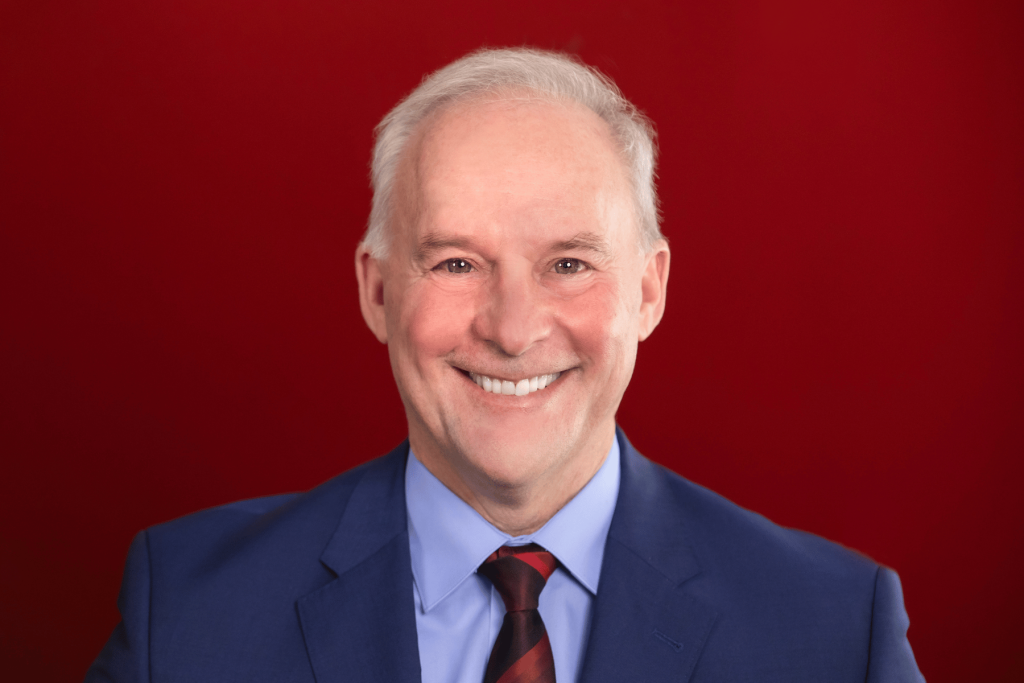 George Burton in front of red gradient background