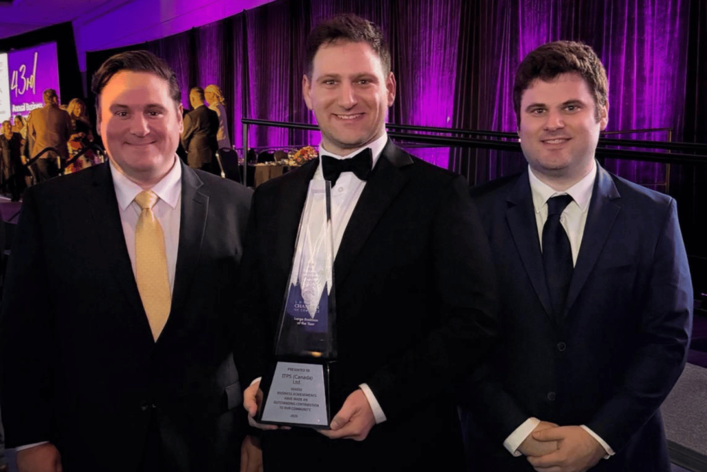 David, Vincent, and Carlo Clementi with trophy at business awards event