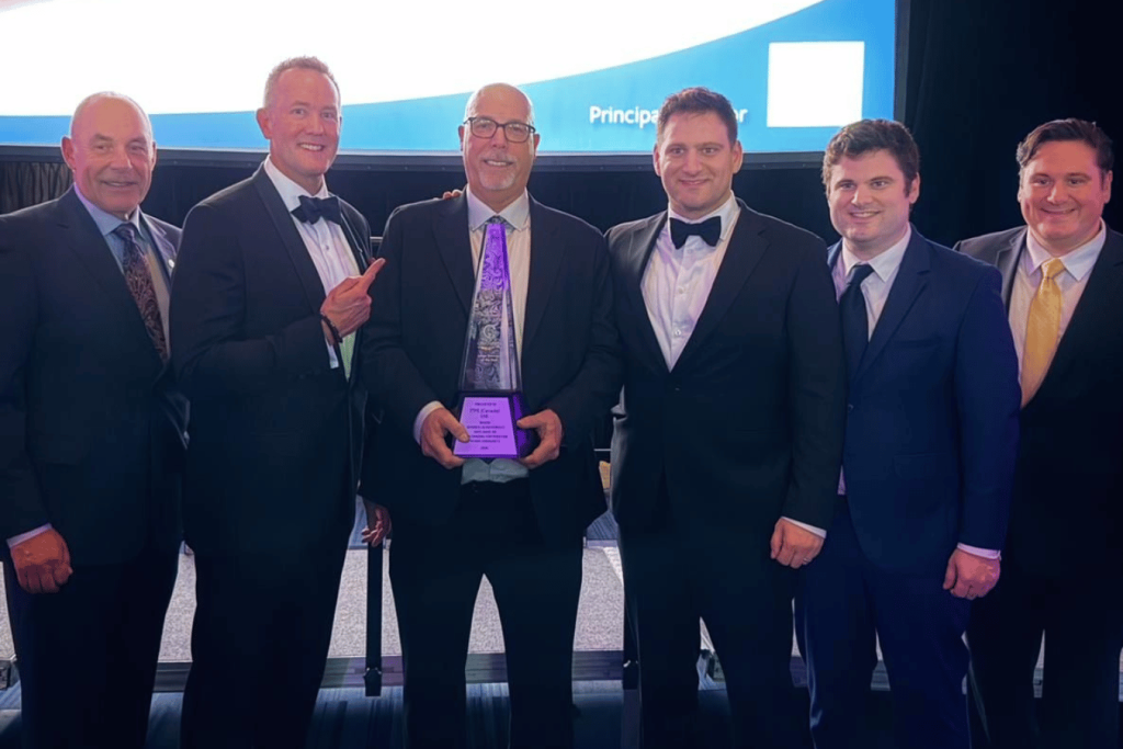 ITPS team standing together with London Chamber Large Business Award Trophy