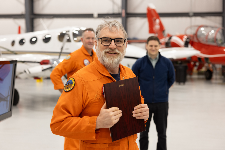 Adam Lowes holding plaque