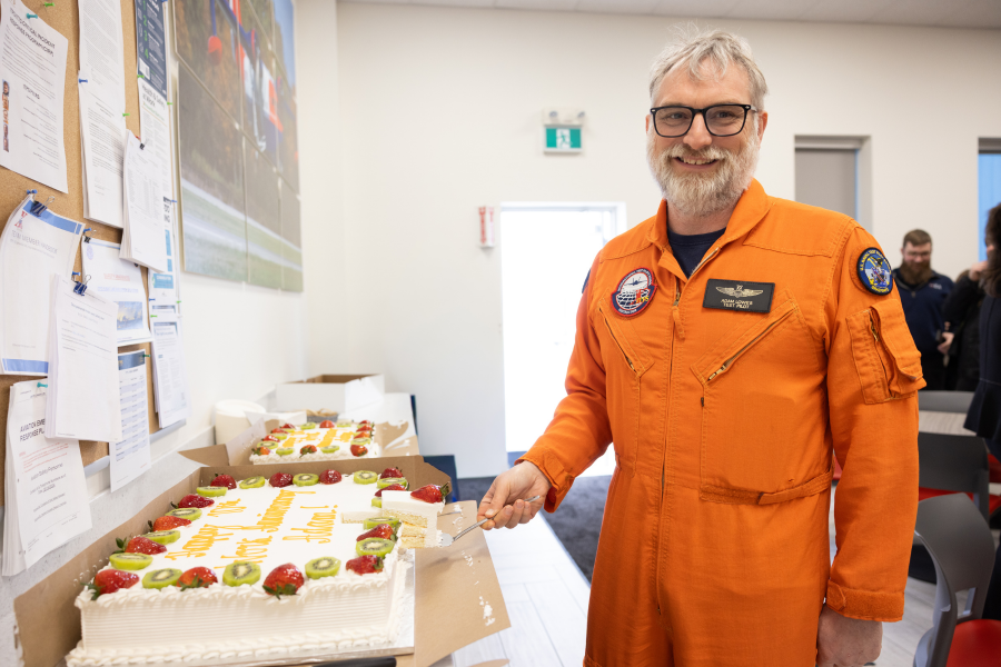 Adam Lowes cutting 10th anniversary cake