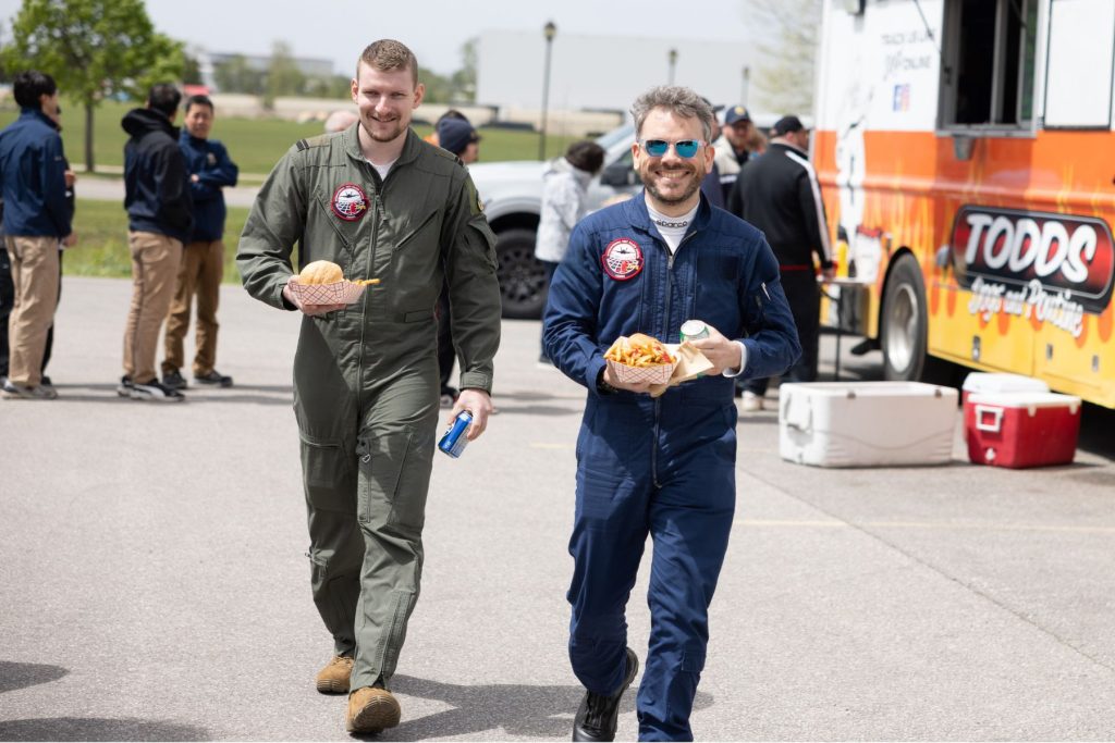 yes (6) Two ITPS students smiling holding food in front of food truck