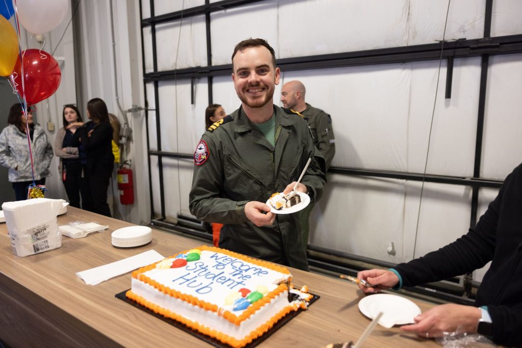 yes (8) ITPS student smiling holding plate of cake