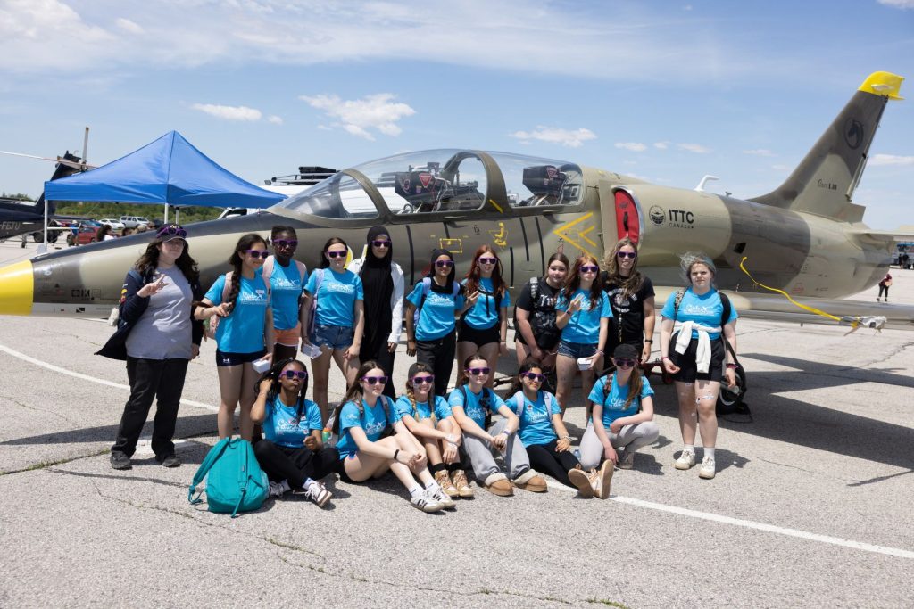 group of girls and young women in front of L39 jet
